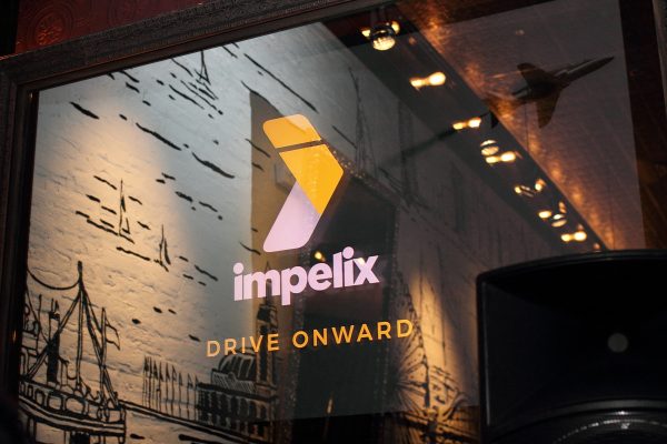 impelix logo and tag line on television - sd-wan event with velocloud - the madison bar and kitchen chicago - april 2018